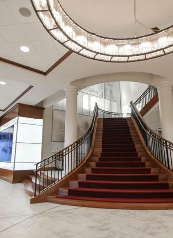 Powder coated curved staircase railing in a lobby